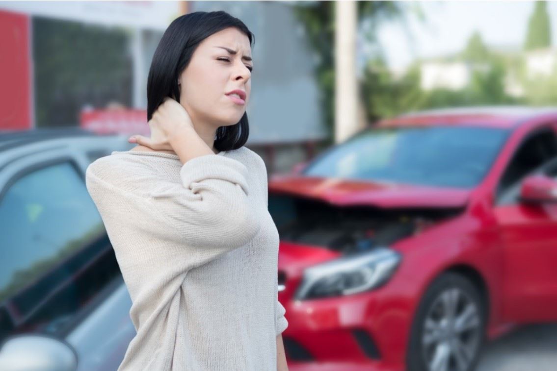 woman rubbing her injured neck after a car accident