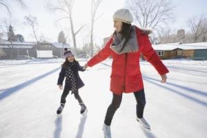 Mother and daughter ice skating outside