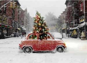 small car driving through the snow