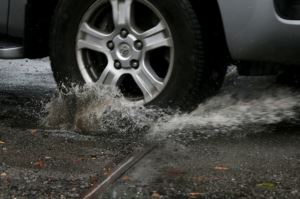 car driving through a pothole