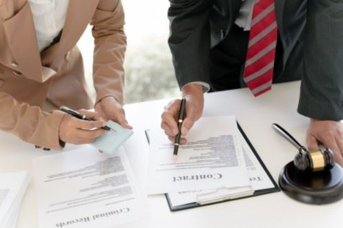 lawyer and his client going over legal paperwork