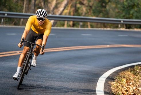 man cycling on the road