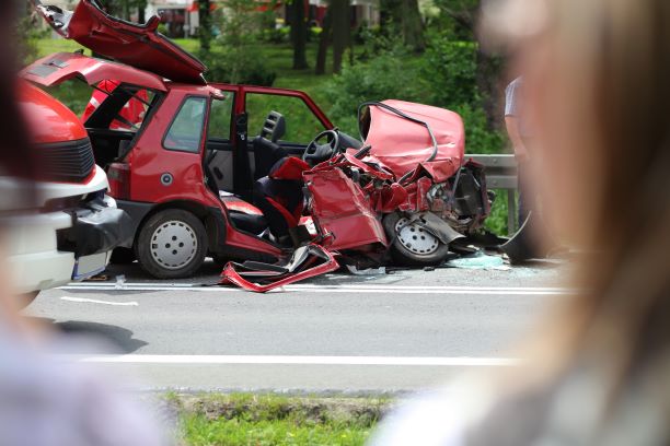 woman standing looking at a wrecked car after drunk driving accident